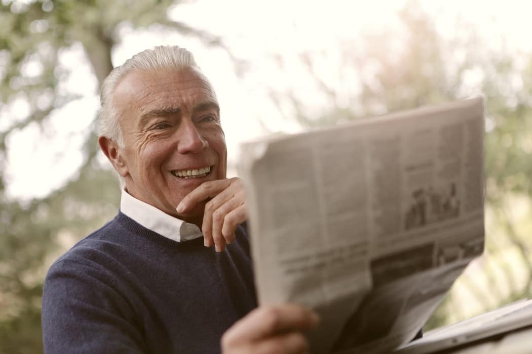 Man reading a newspaper.