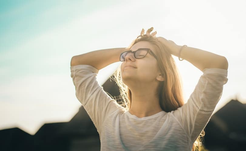 Woman stretches and relaxes outdoors.