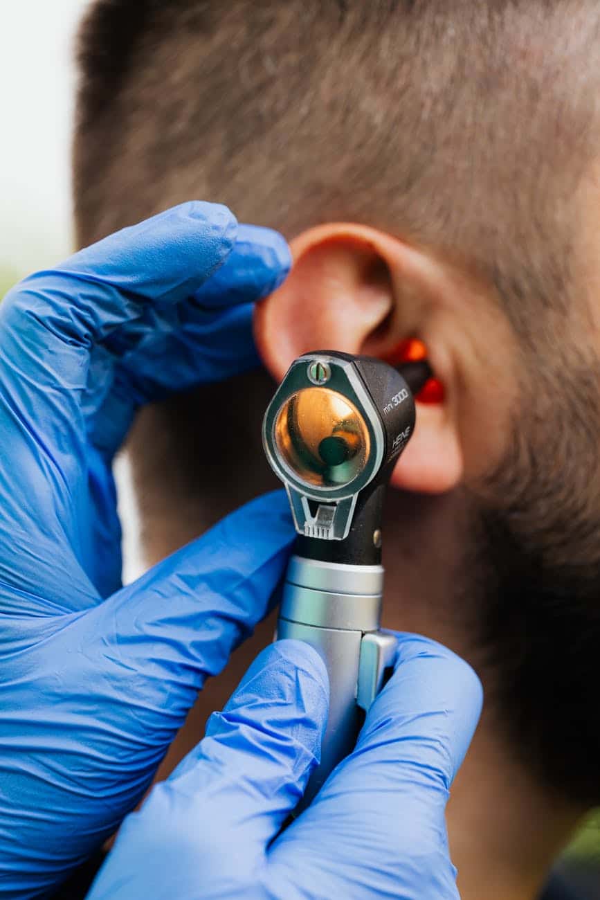 Man gets an ear exam.