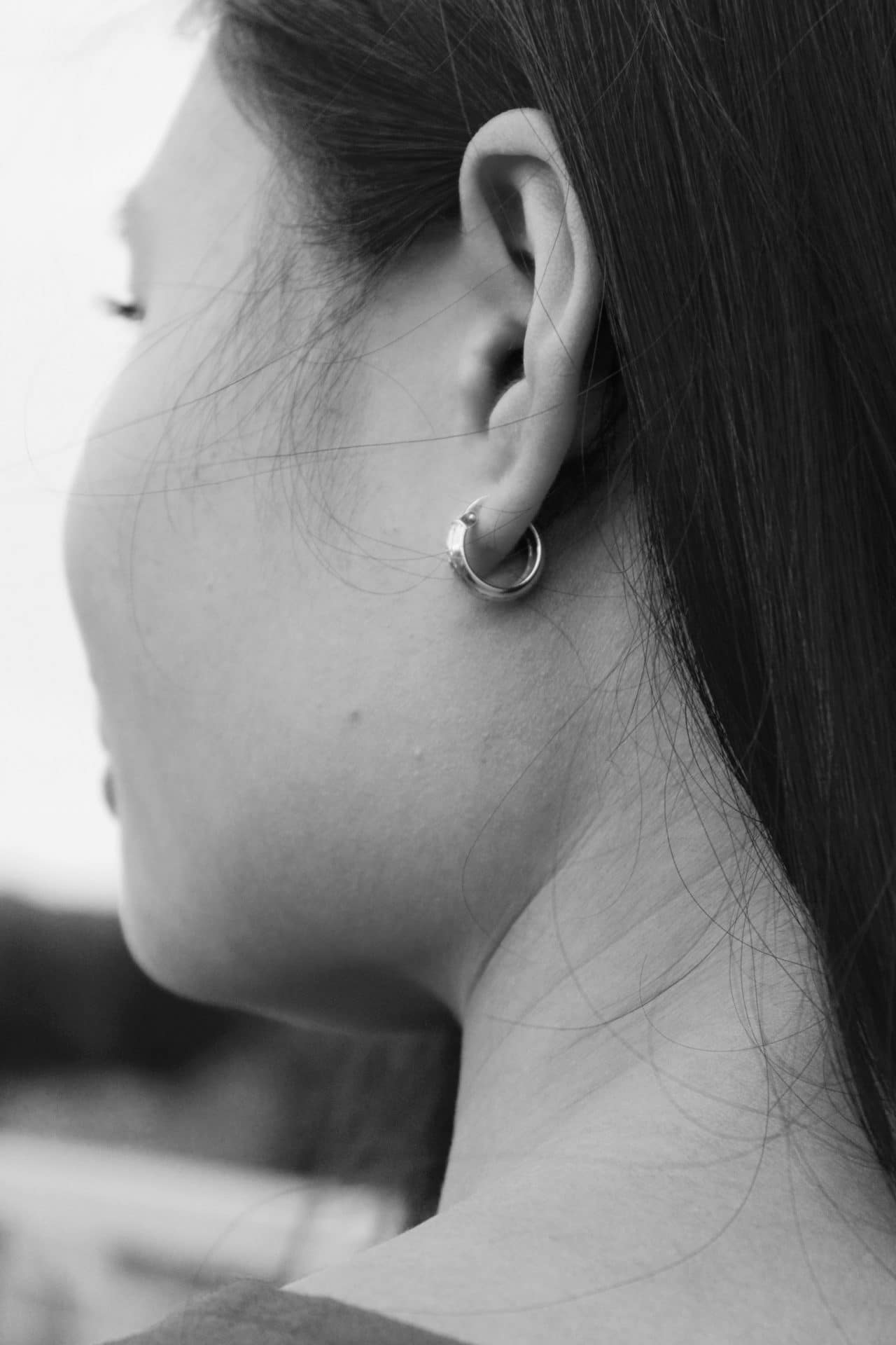 Black-and-white close-up of a woman's ear