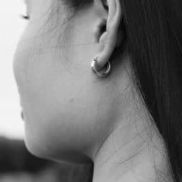 Black-and-white close-up of a woman's ear