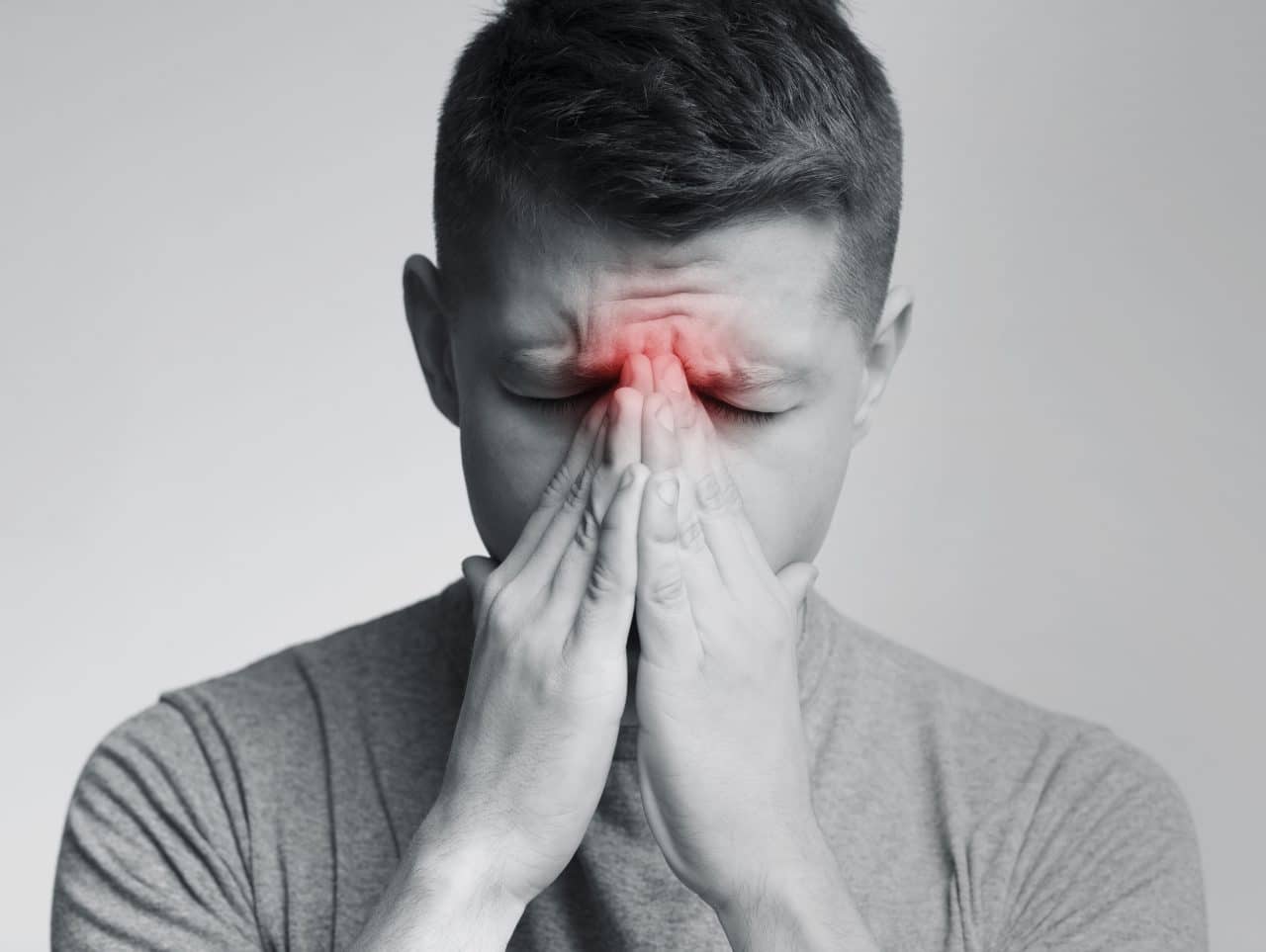 Man experiencing sinus pressure due to allergies.
