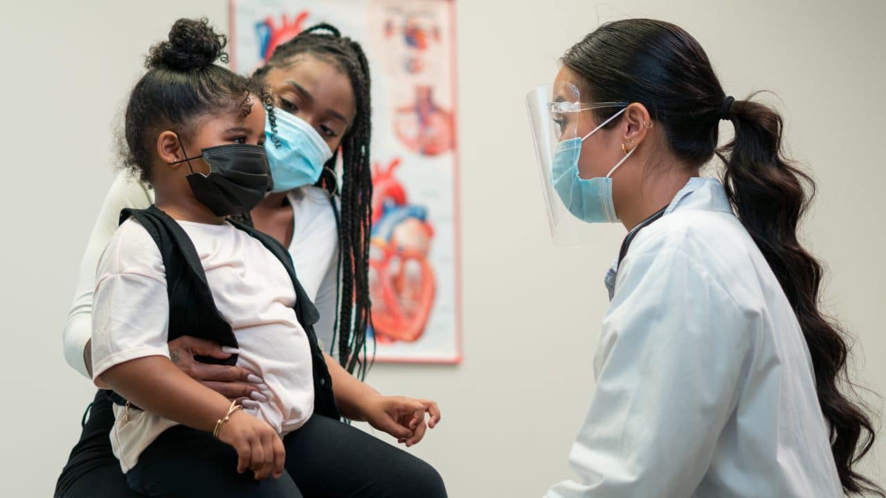 Mom and daughter take a trip to the doctor's office for an appointment.