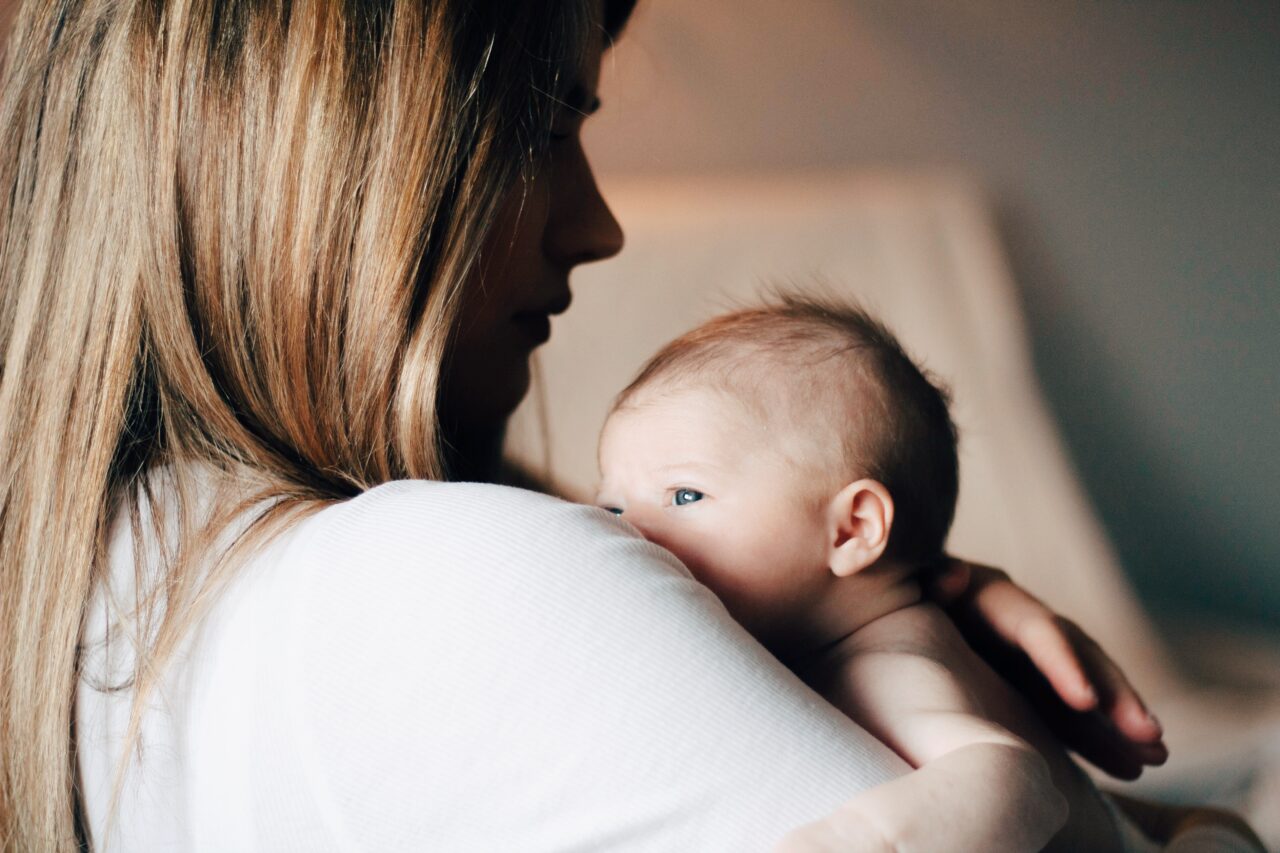 Woman holding her newborn child.