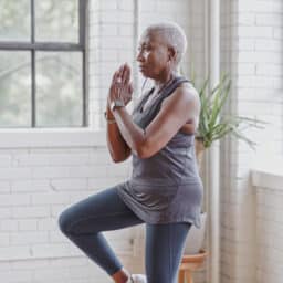 Woman doing yoga balancing on one leg