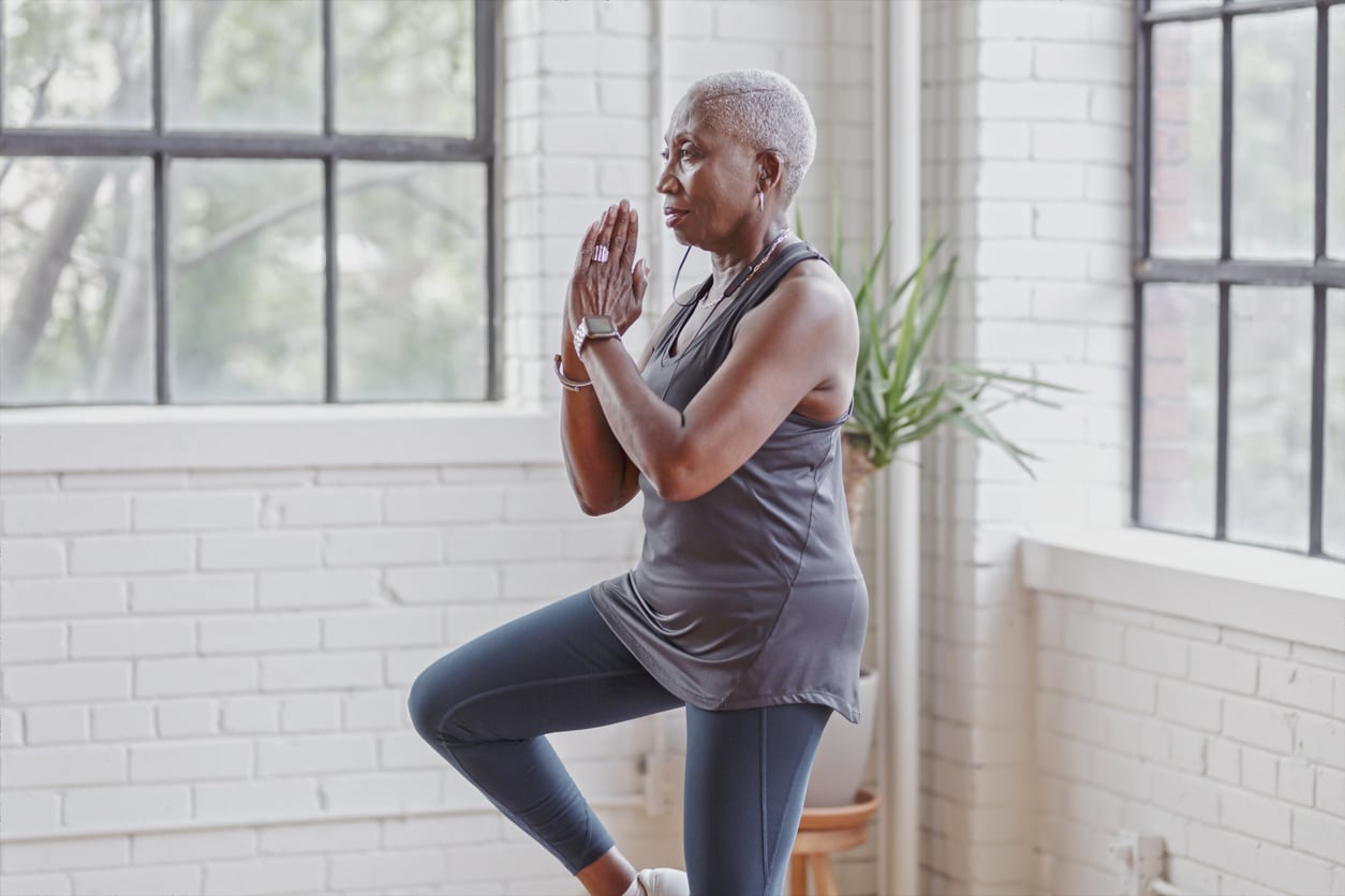 Woman doing yoga balancing on one leg