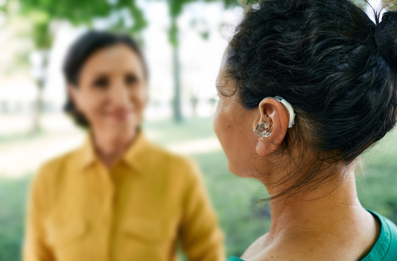 Woman with hearing loss interacts with a friend