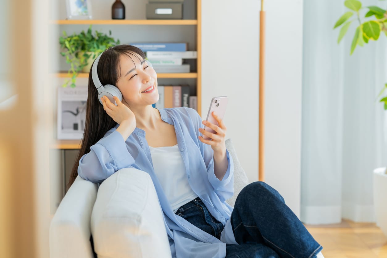 Happy woman listening to an audiobook.